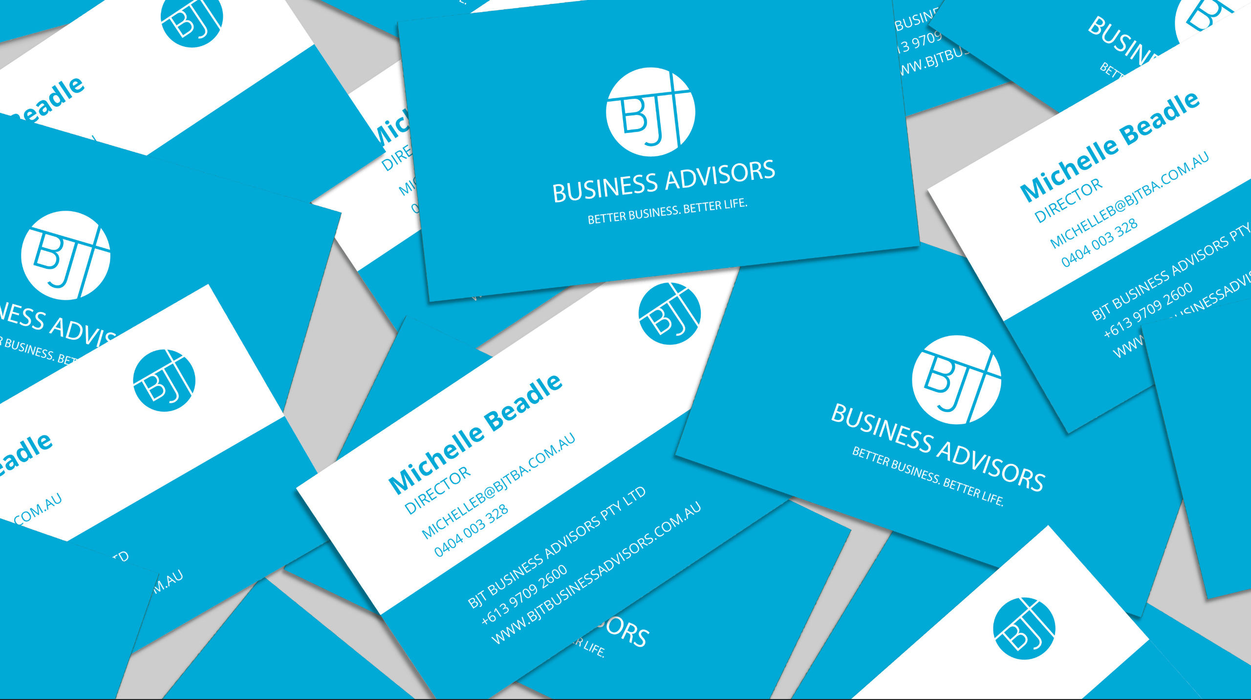Stack of blue and white business cards with BJT Business Advisors branding
