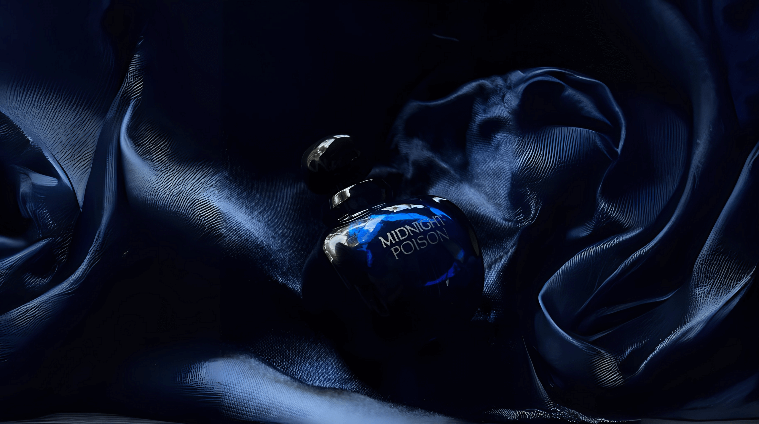 Midnight Poison perfume bottle on deep blue satin fabric