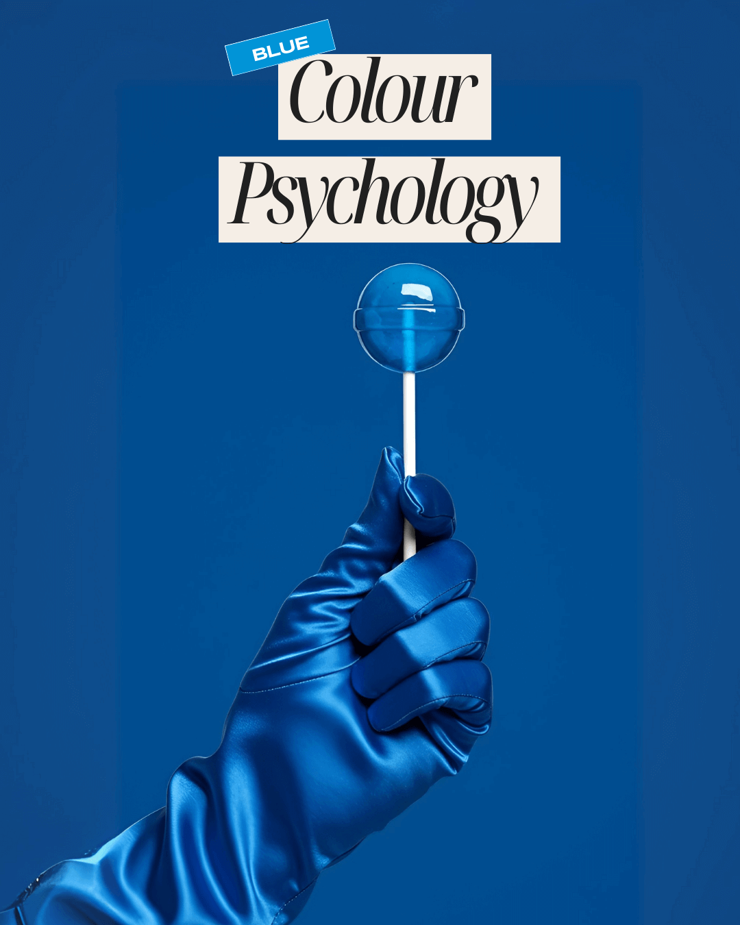 Blue satin glove holding a glossy blue lollipop