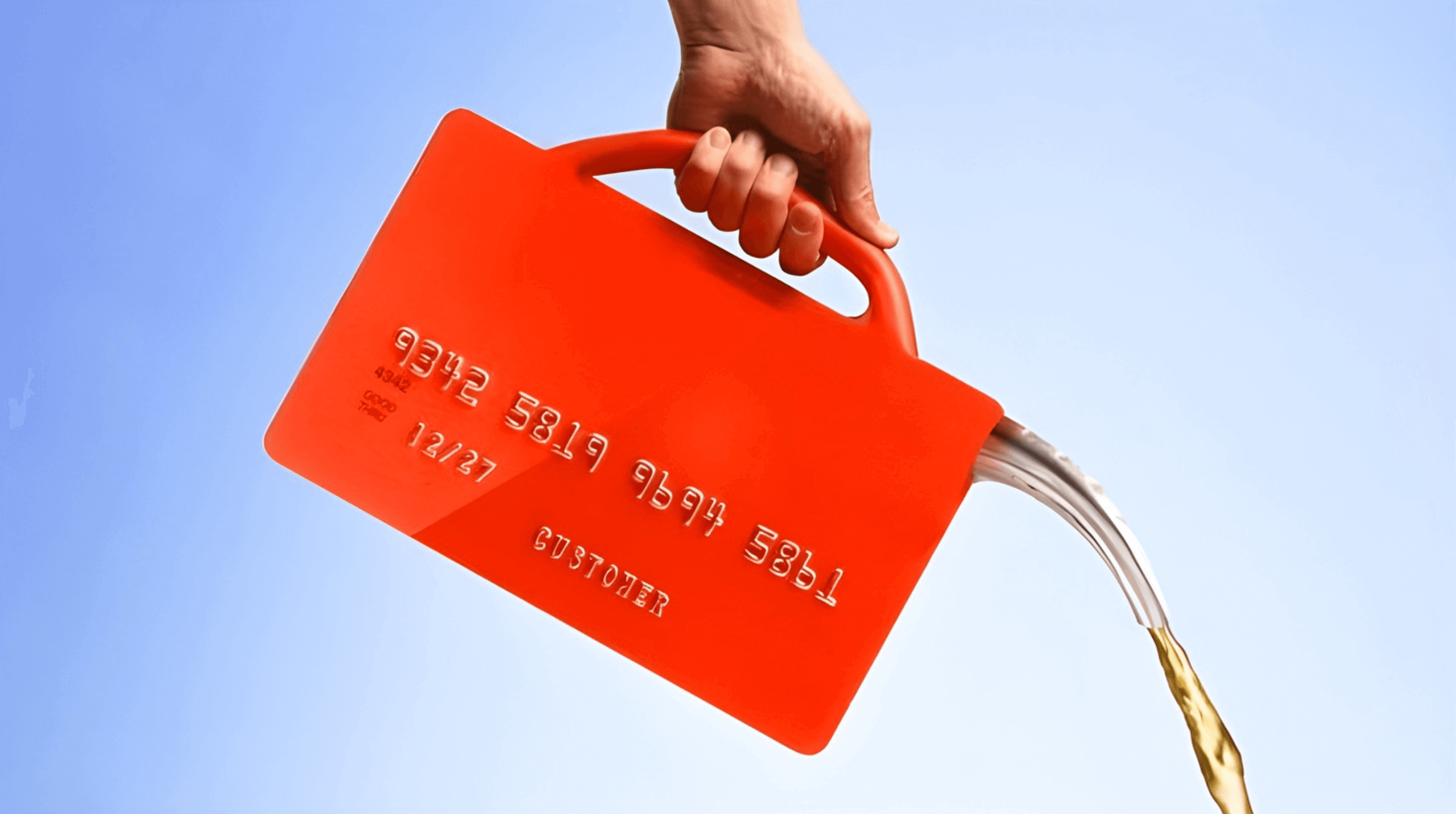 A hand pouring liquid from a bright red credit card shaped container against a blue sky.