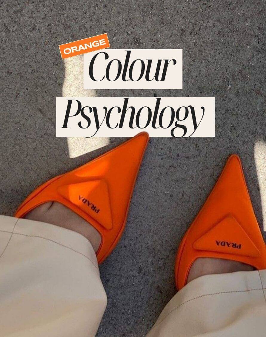 Close-up of a person wearing bright orange Prada pointed-toe shoes with text overlay reading “Orange Colour Psychology.”
