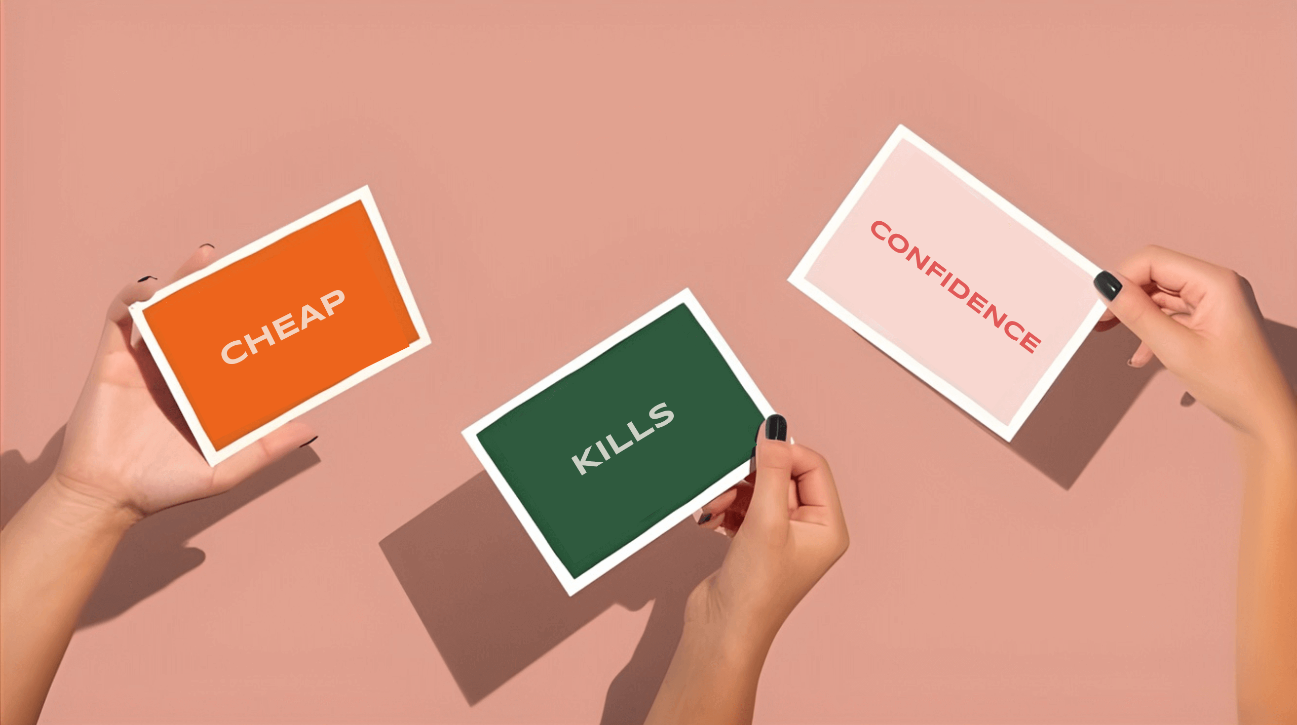 Three hands holding coloured cards with the words Cheap Kills Confidence against a soft pink background.